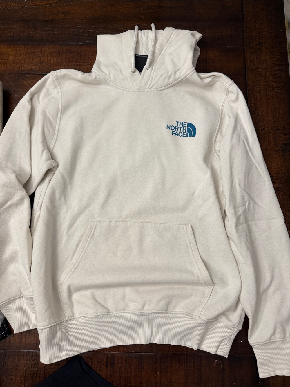 The North Face Men's Cream Hoodie with Blue Logo